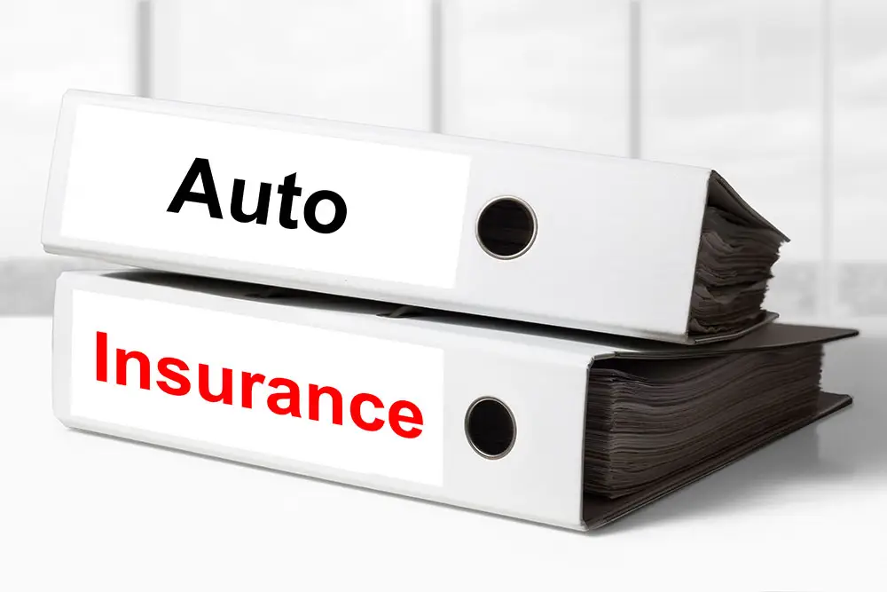 Two white office binders labeled Auto and Insurance, representing a complete guide to auto insurance in washington state.