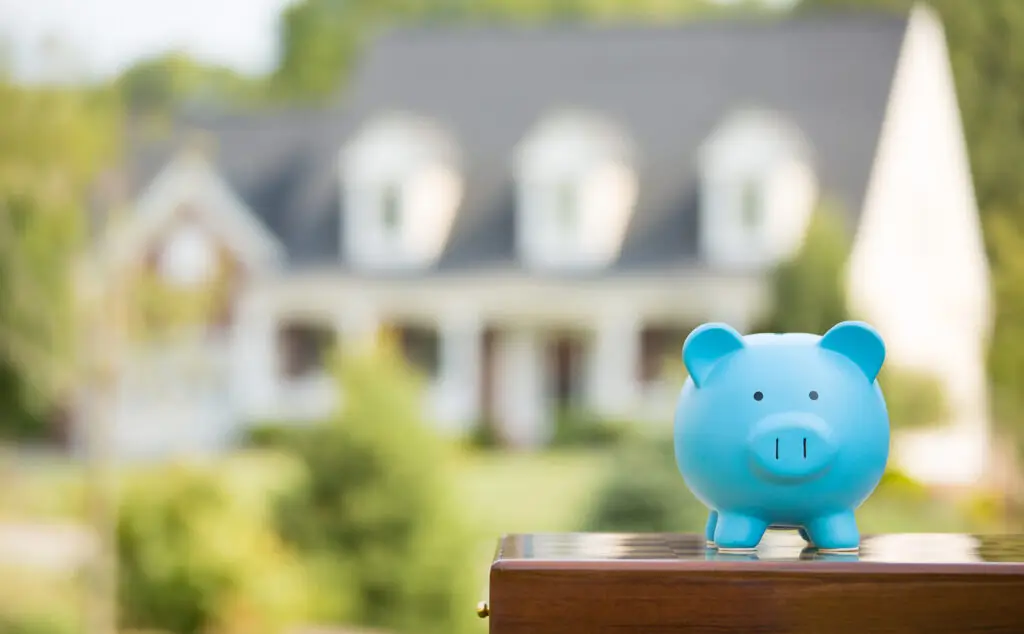 Piggy bank isolated outside home on background. Focus on piggy bank.